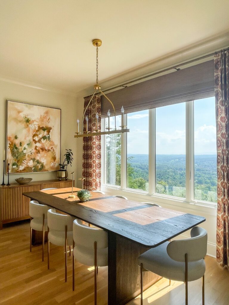 Chattanooga dining room with custom drapery and woven wood shades framing a large window with scenic views