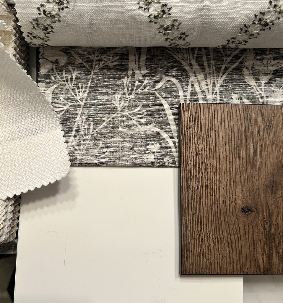 Interior design sample board with fabric, wallpaper, paint, and wood flooring selections